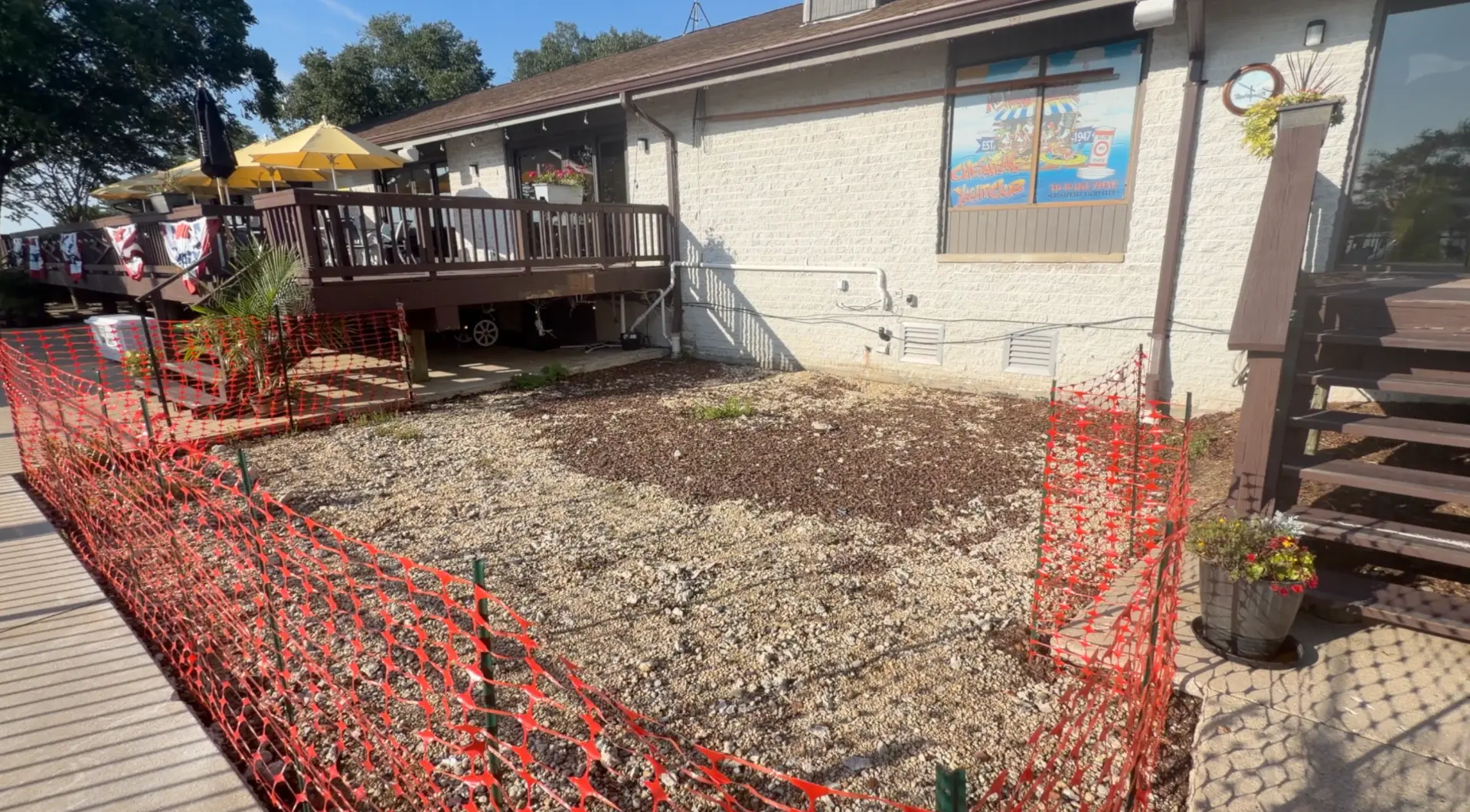 Outdoor dining improvement construction area with gravel and safety fencing
